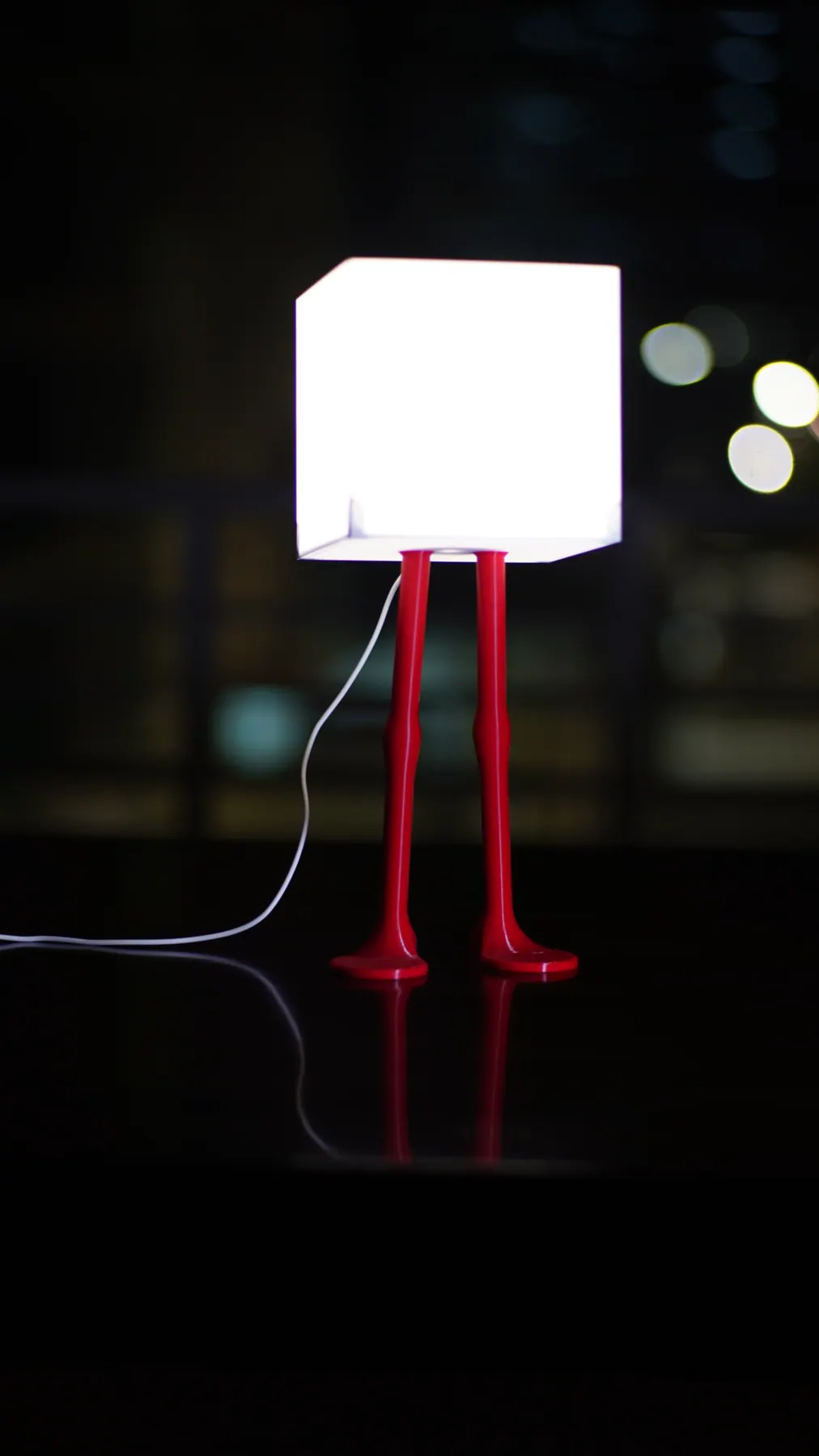 Flamingo Light, standing pose: a glowing cube shade on two red legs